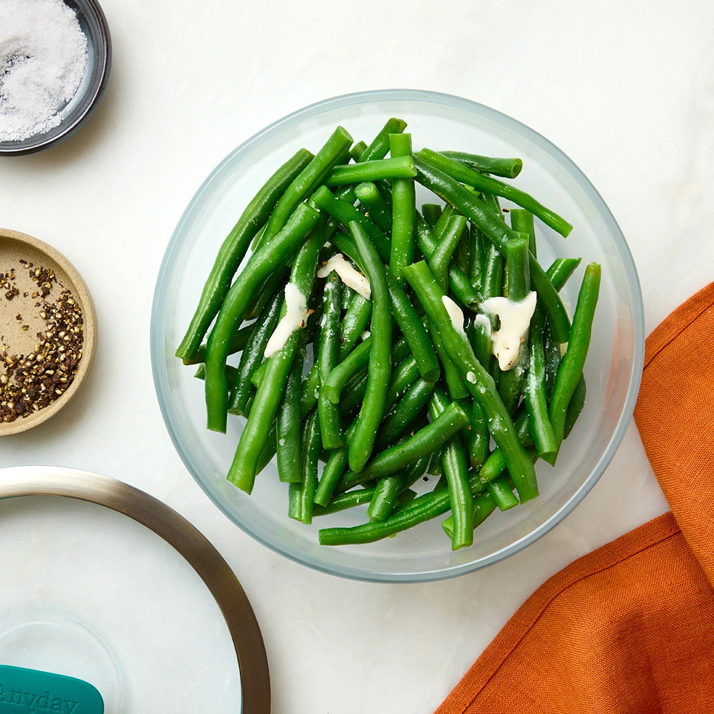 Perfectly cooked green beans made and served in the glass Anyday dish, providing tender and crisp beans. This method ensures evenly cooked green beans, ideal for a nutritious and easy side dish.