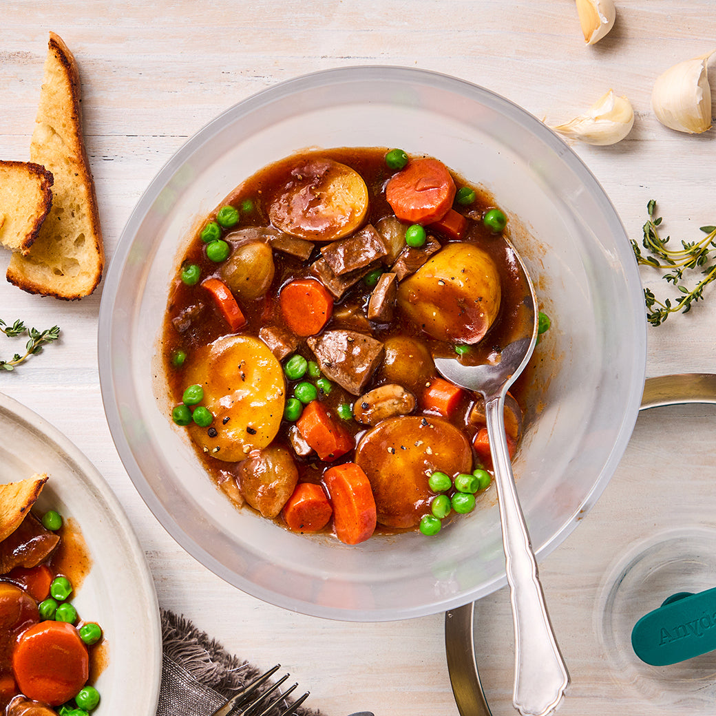 An Anyday dish filled with beef stew, showing chunks of tender beef, potatoes, and carrots in a rich broth