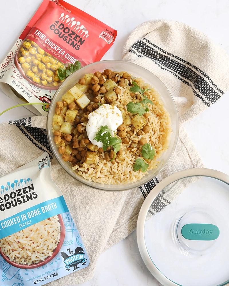 Delicious and quick chickpea curry by A Dozen Cousins with added potatoes made in the glass Anyday dish. Served with rice, cilantro and sour cream.