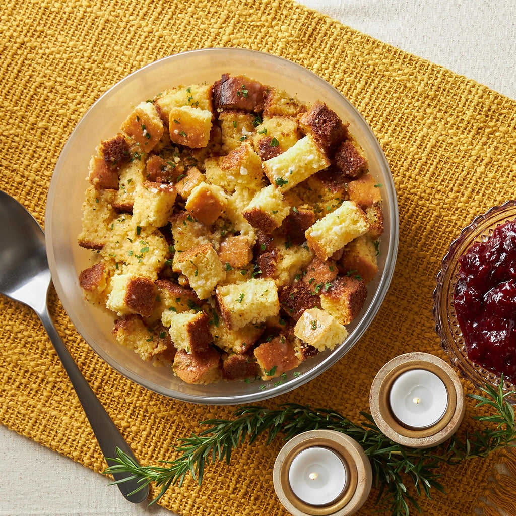 Cornbread Stuffing made and served in the glass Anyday dish, featuring moist cornbread mixed with savory herbs.