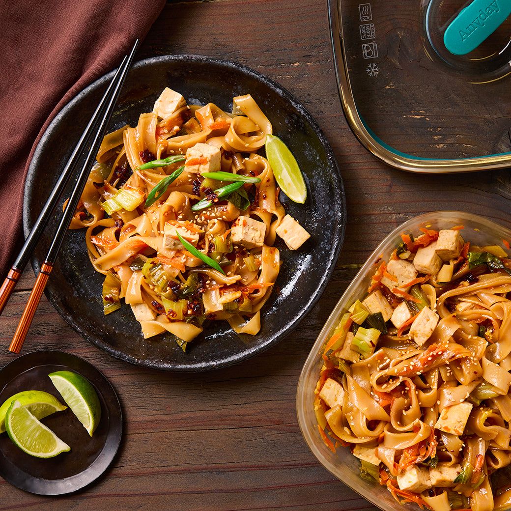 Microwave Drunken Noodles with chicken cooked in an Anyday dish—chewy rice noodles, tofu, and vibrant veggies tossed in a bold, savory sauce for a quick and flavorful meal.