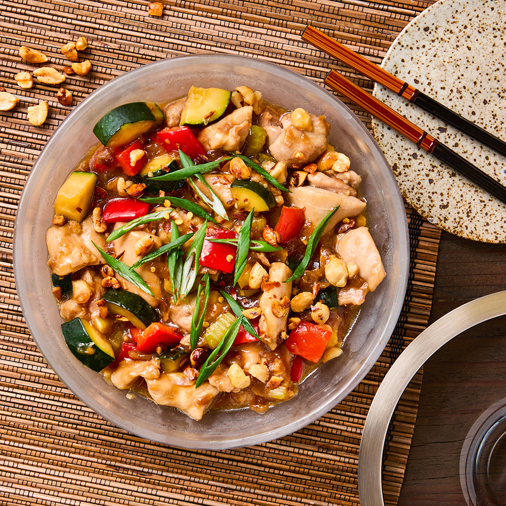 Microwave Kung Pao Chicken cooked in an Anyday dish—tender chicken, crunchy peanuts, and peppers in a savory, spicy sauce, all made quickly in the microwave.