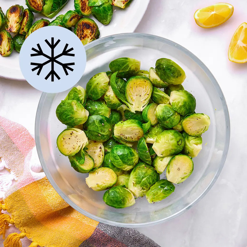 Frozen Brussels sprouts in a clear Anyday dish, lightly steamed with lemon and pepper