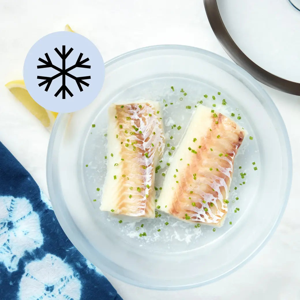 Frozen cod fillet in a clear Anyday dish with lid off to the side