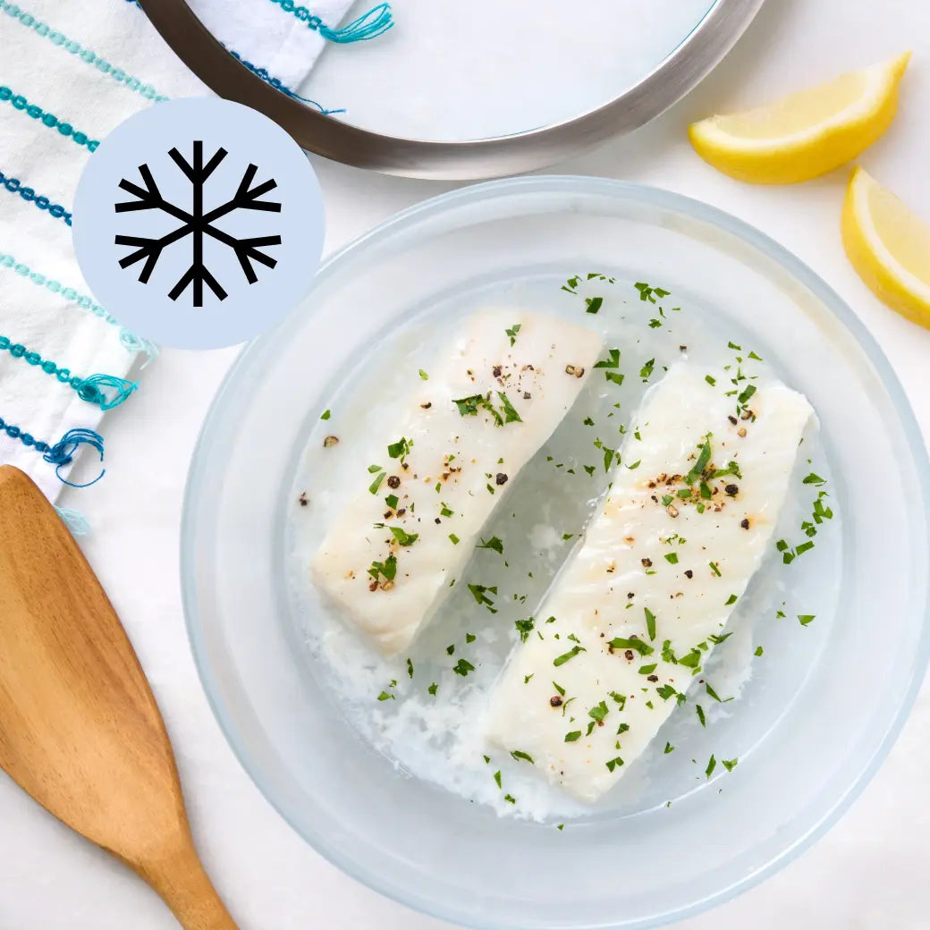 Frozen halibut fillet in a glass Anyday dish before cooking, on a neutral background