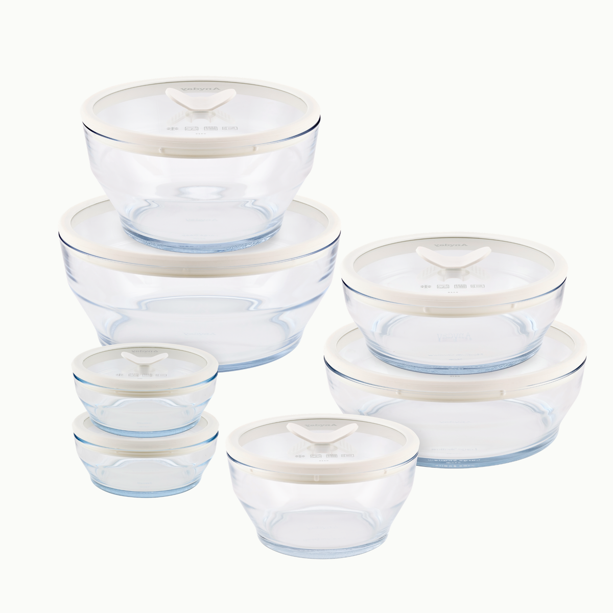 A 14-piece clear glass round dish set—featuring food storage containers of assorted sizes, each with a white lid—grouped on a white background; ideal for a plastic-free kitchen and safe for use as microwave cookware.