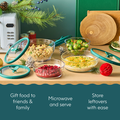 Four Steph’s Must-Haves (kale) glass dishes with glass lids containing cooked food and cranberries on a wooden surface, with text reading Gift food to friends & family, Microwave and serve, Store leftovers with ease.