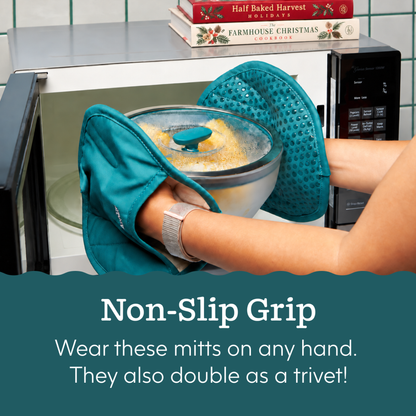 Hands wearing teal silicone mitts removing an Anyday The Ultimate Gift Bundle (kale) frosted glass square set dish from a microwave.