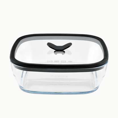 Anyday 10-Cup Glass Square Shallow Dish in Black Sesame, a square frosted glass food storage container with a vented glass lid featuring a black silicone rim and a black center vent handle.