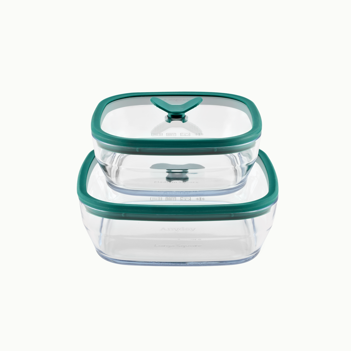Two frosted glass Anyday 4-Piece Glass Square Dish Set containers in Kale stacked on top of one another with green silicone lids.
