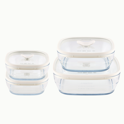 Four Anyday 8-Piece Glass Square Dish Set dishes in Mochi frosted glass, each with a clear glass lid featuring a central handle and off-white trim.