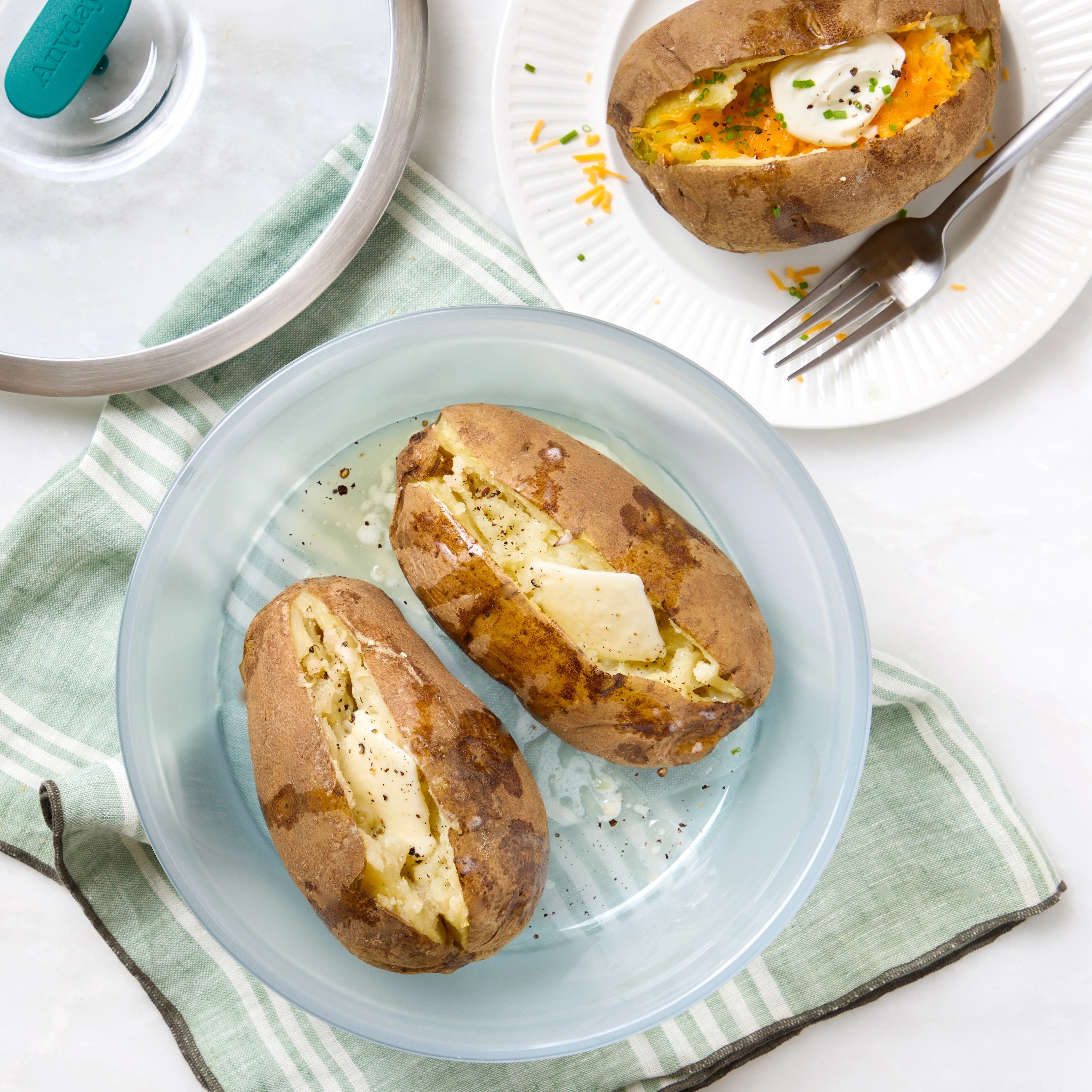 A soft, fluffy baked potato in an Anyday dish, cooked in the microwave for a quick, easy meal.