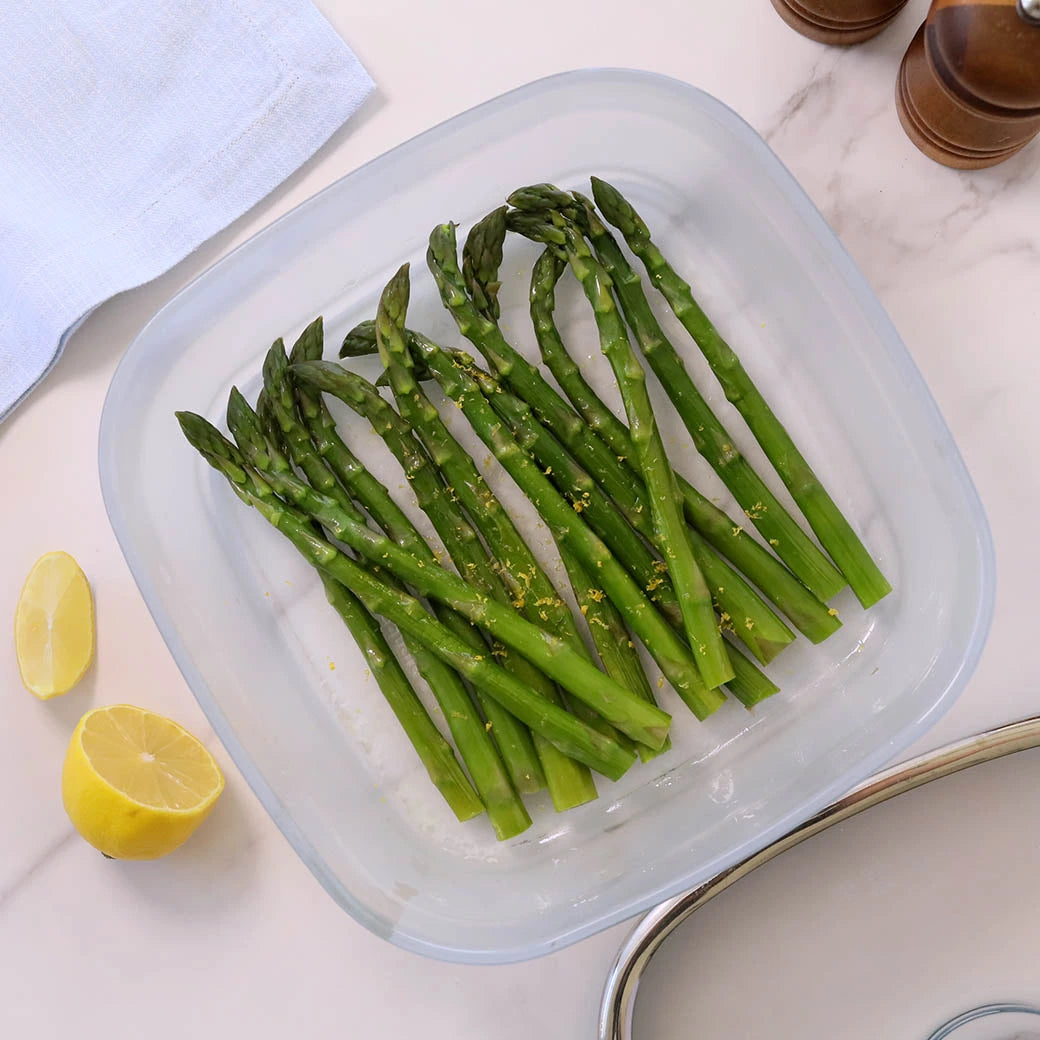 Asparagus cooked and served in the glass Anyday dish, featuring tender, steamed asparagus spears perfect as a healthy side dish.