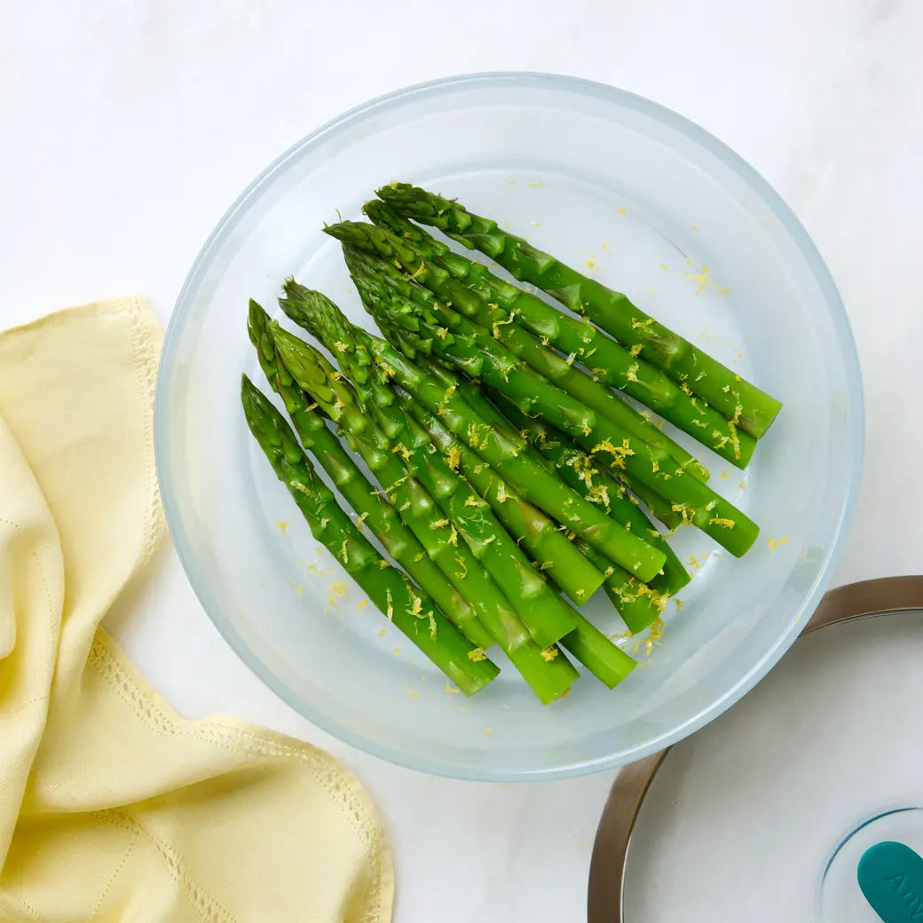 Asparagus cooked and served in the glass Anyday dish, featuring tender, steamed asparagus spears perfect as a healthy side dish.