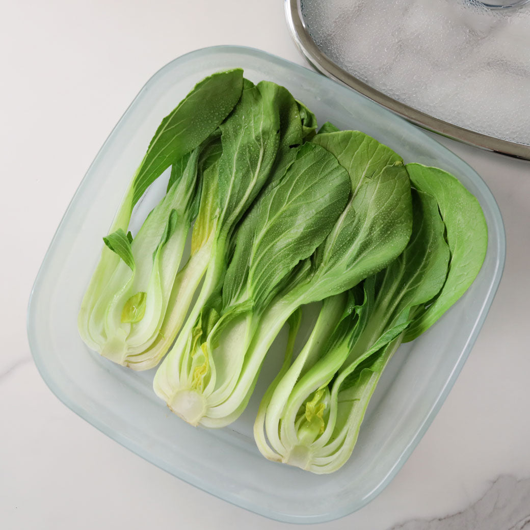 Bok Choy is cooked and served in a glass Anyday dish, featuring tender, steamed bok choy perfect for adding to stir-fries, soups, or as a healthy side dish.