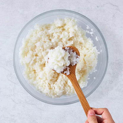 Fluffy white rice cooked in 10 minutes, served in a clear Anyday dish on a light surface with a fork and lid nearby.
