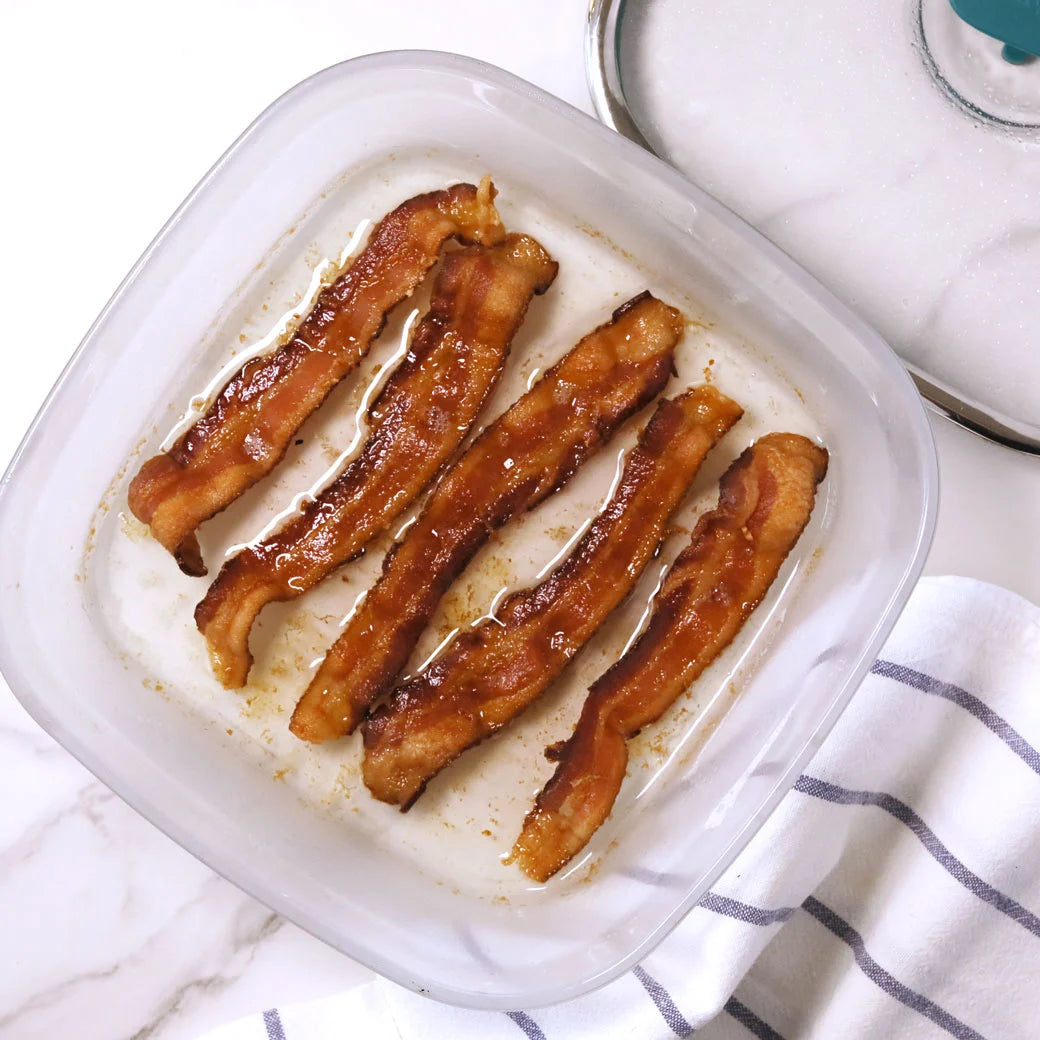 Bacon cooked and served in the glass Anyday dish, featuring crispy, perfectly cooked bacon strips with no splatter.