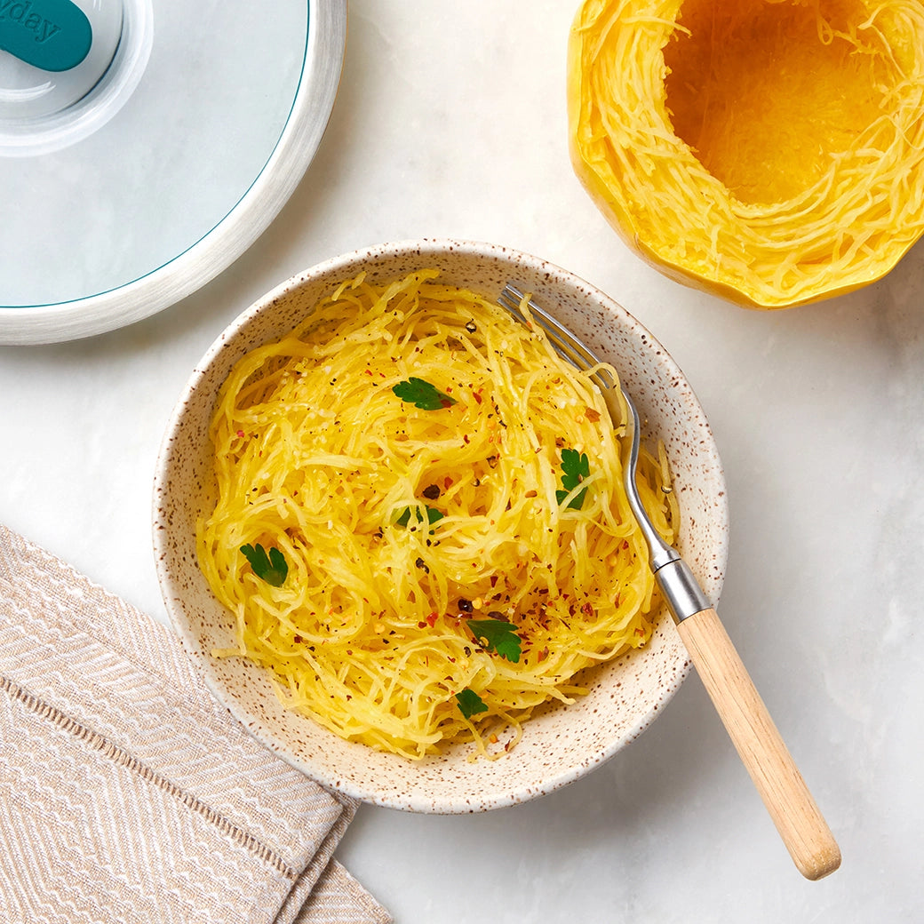 Perfectly cooked spaghetti squash made and served in the glass Anyday dish, providing tender, strand-like squash. This method ensures evenly cooked spaghetti squash, ideal for a low-carb pasta alternative or as a healthy side dish.