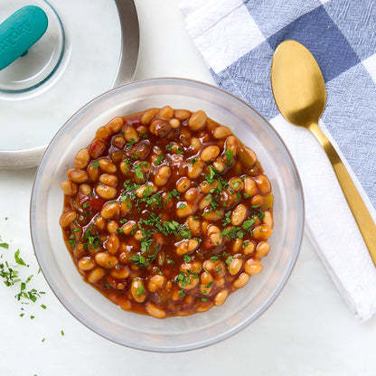 Almost from scratch BBQ Baked Beans made in the glass Anyday dish, consisting of canned beans, onions, and smoky BBQ sauce. This method ensures tender and flavorful beans, ideal for a hearty side dish or main meal.