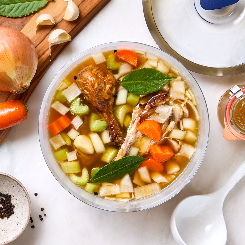 Flavorful bone stock made in the glass Anyday dish, featuring tender chicken, aromatic vegetables, and herbs. This easy microwave recipe delivers a rich and savory homemade stock, perfect for soups, stews, and enhancing various dishes.