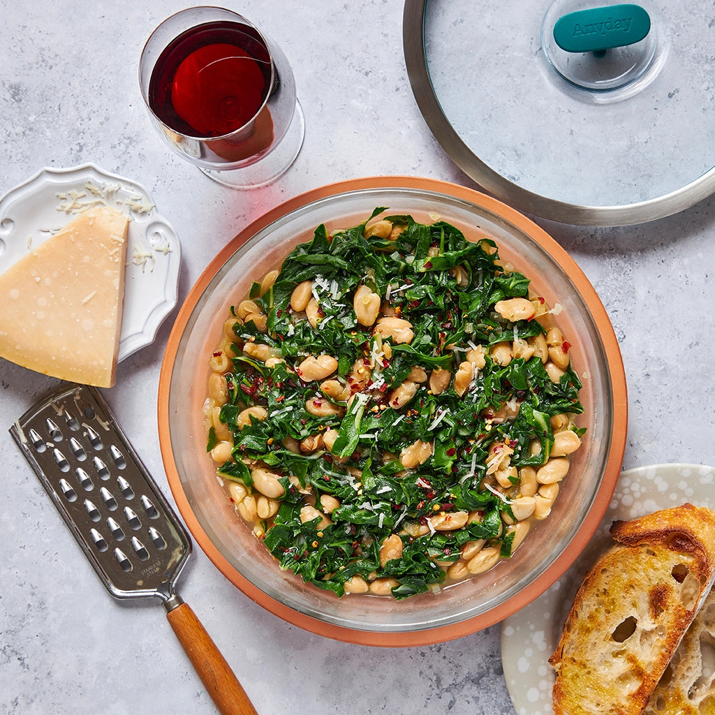 Delicious Italian beans and greens made in the glass Anyday dish, which consists of tender white beans, vibrant greens, and savory Italian seasonings. This quick and healthy microwave recipe delivers a flavorful and nutritious meal, perfect for a satisfying dinner.