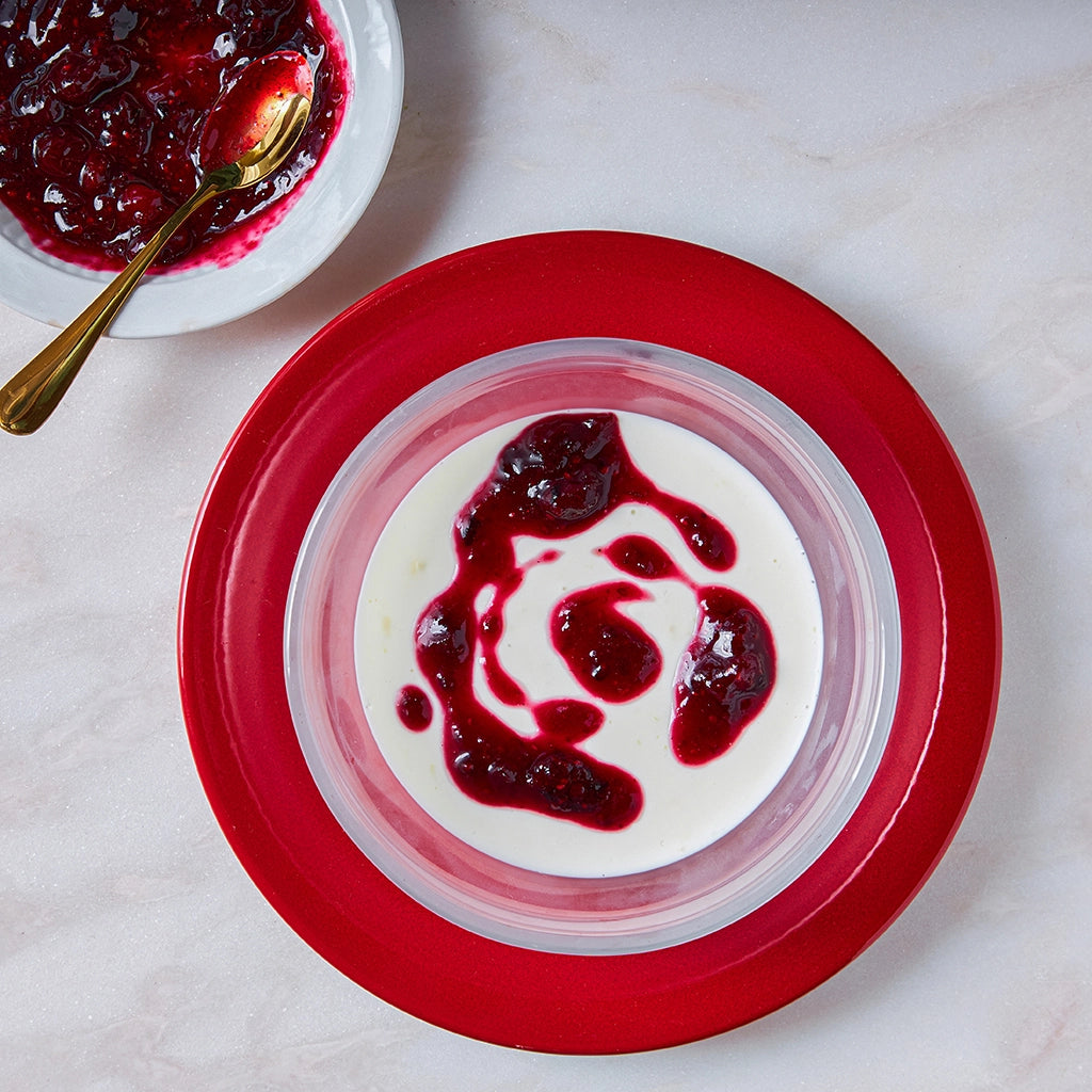 Buttermilk Panna Cotta with Berry Sauce made in the glass Anyday dish, featuring a creamy panna cotta topped with a vibrant red berry sauce.