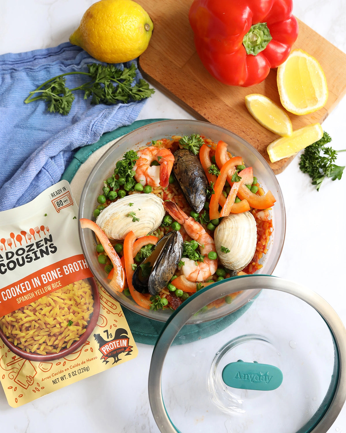 No fuzz seafood rice made with A Dozen Cousins Spanish Yellow Rice, made in the glass Anyday dish. Perfect for a quick meal packed with seafood.