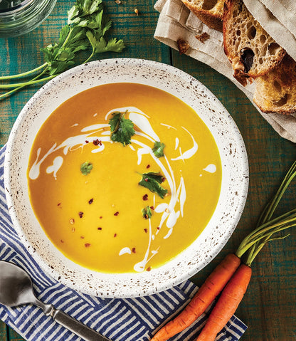 Carrot and Coriander Soup made and served in the glass Anyday dish, featuring a smooth blend of carrots and fresh coriander.