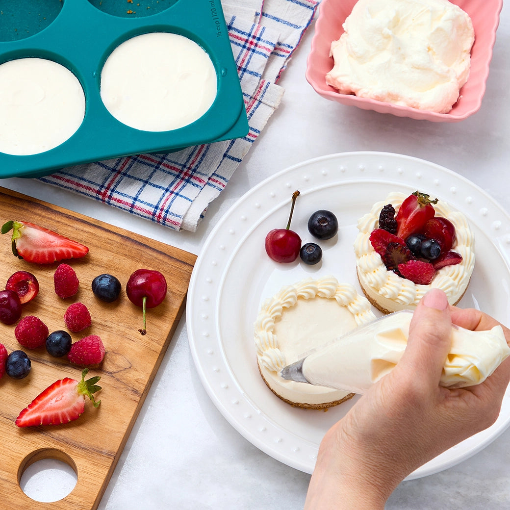 Super quick cheesecake bites made in the silicone Anytime Freezer Trays, consisting of creamy custard on a buttery graham crust. This method ensures rich and smooth bite-sized treats, perfect for a quick and delicious dessert.