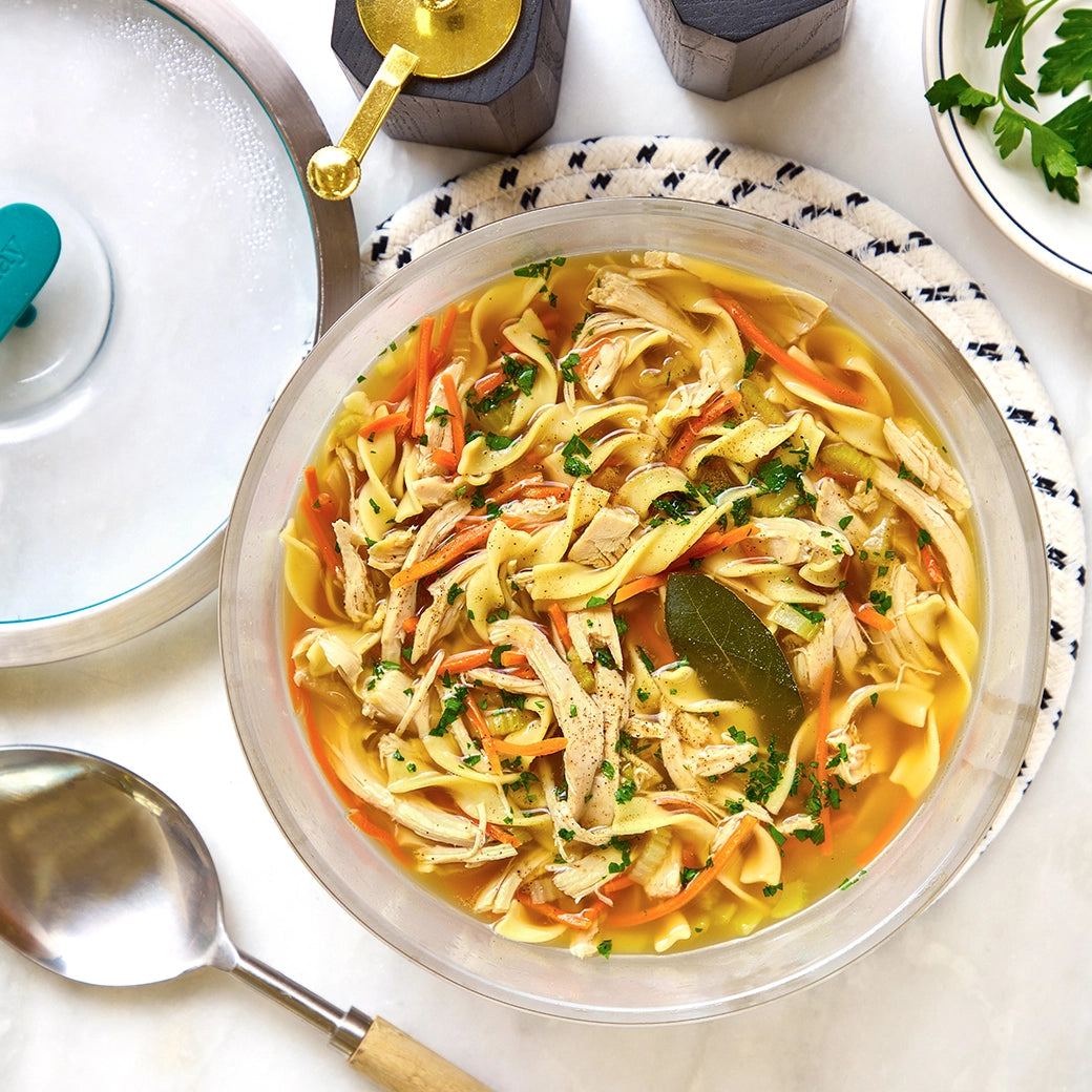 Chicken Noodle Soup made and served in the glass Anyday dish, featuring tender chicken, noodles, and vegetables in a comforting broth.