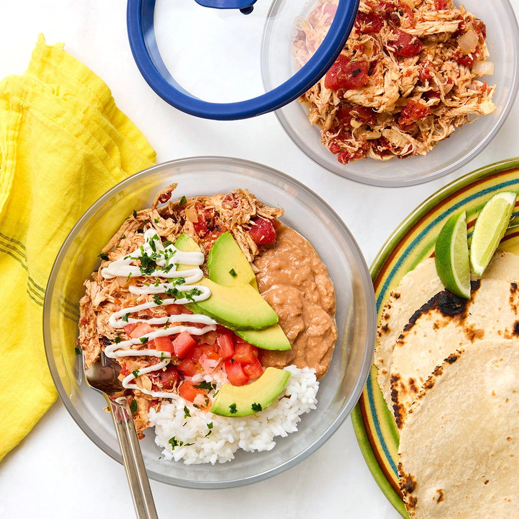 Chicken Tinga Taco Bowls made and served in the glass Anyday dish, featuring shredded chicken in a spicy tomato sauce, served with rice, beans, and fresh toppings.