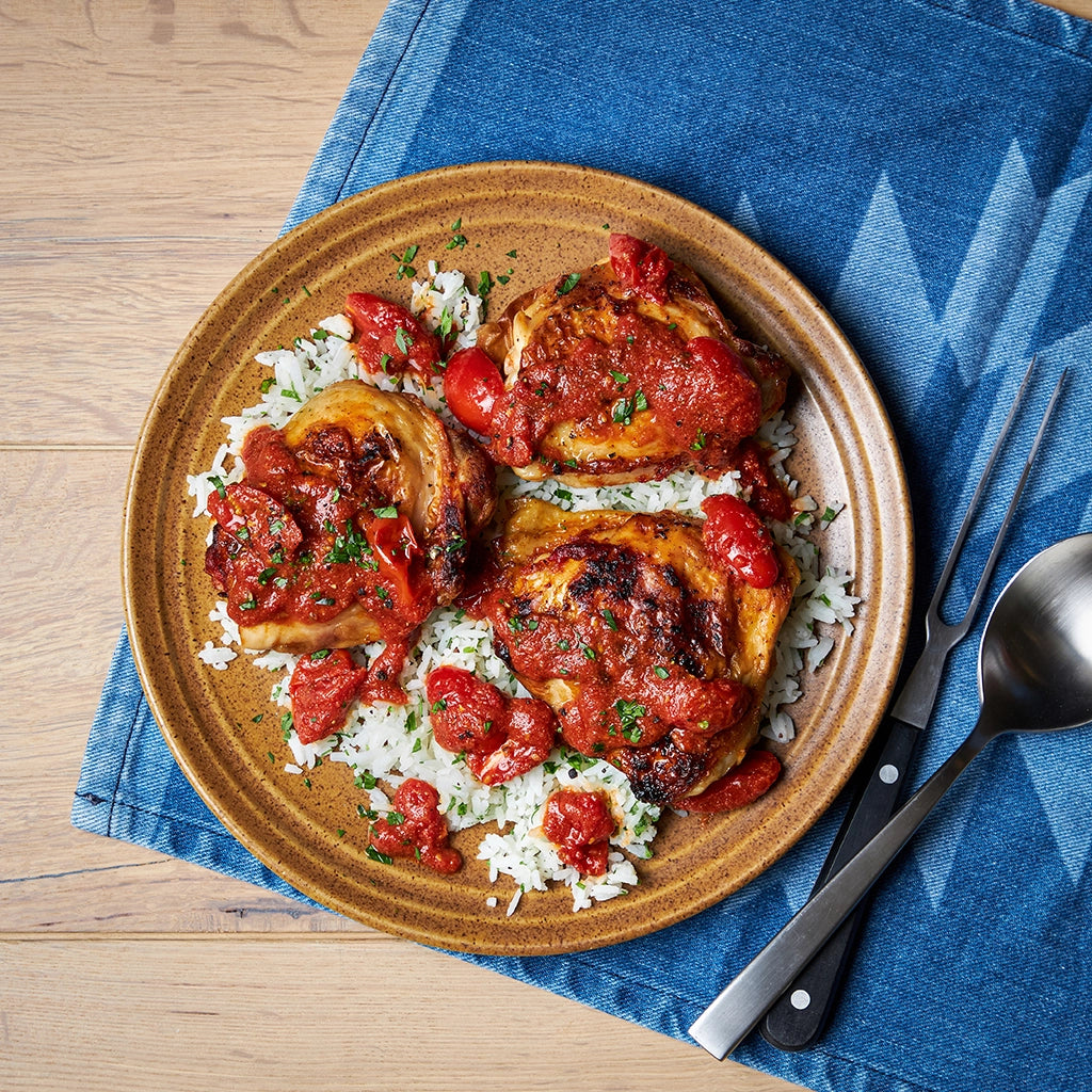 Chicken with Saucy Tomatoes made and served in the glass Anyday dish, featuring tender chicken pieces in a rich cherry tomato sauce with herbs.