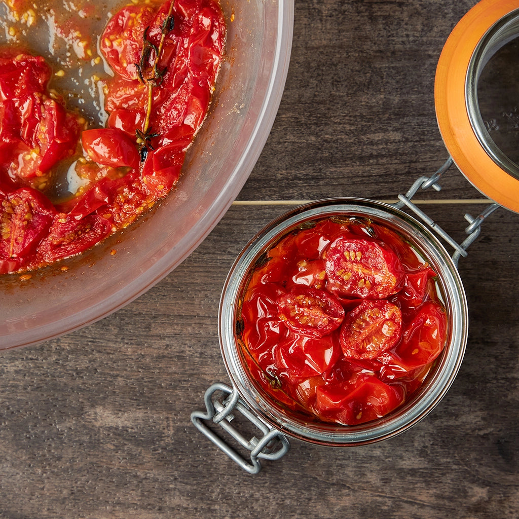 Confit Tomatoes made and served in the glass Anyday dish, featuring slow-cooked cherry tomatoes in olive oil with garlic and herbs.