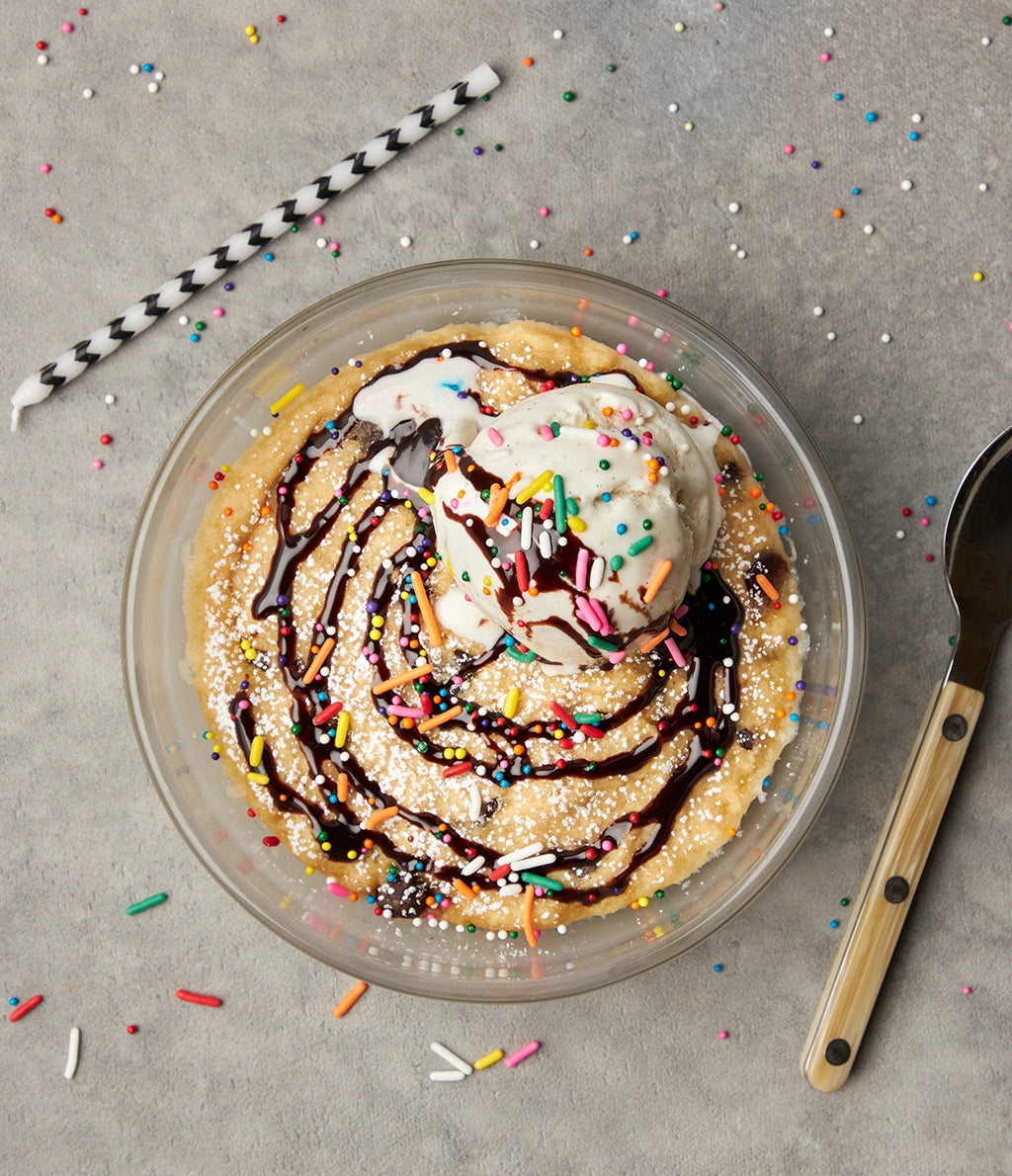 Chocolate Chip Cookie Cake made and served in the glass Anyday dish, featuring a soft and chewy cookie cake loaded with chocolate chips.