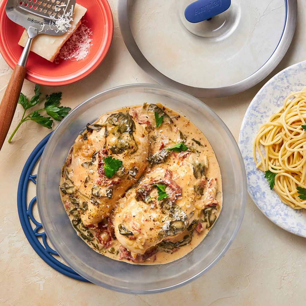 Creamy Tuscan Chicken made and served in the glass Anyday dish, featuring tender chicken in a rich, creamy sauce with sun-dried tomatoes, spinach, and garlic.