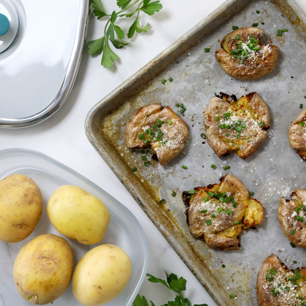 Crispy Smashed Potatoes made and served in the glass Anyday dish, featuring golden brown potatoes finished in a hot pan with a crispy exterior and tender interior, seasoned with herbs.