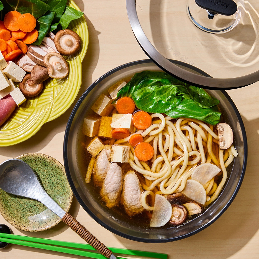 Delicious one-dish sukiyaki made in the glass Anyday dish, featuring tender beef, tofu, vegetables, and a savory soy-based broth. This quick and flavorful David Chang microwave recipe delivers a rich and comforting Japanese hot pot meal, perfect for a satisfying dinner.