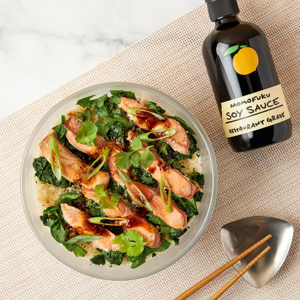 Dave Chang's Salmon Rice made and served in the glass Anyday dish, featuring tender salmon cook at the same time with seasoned rice, garnished with fresh herbs