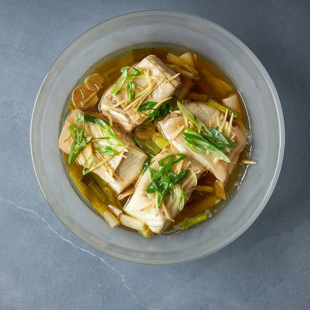 Dave Chang's Steamed Ginger Scallion Fish made and served in the glass Anyday dish, featuring tender fish fillets steamed with fragrant ginger and scallions.