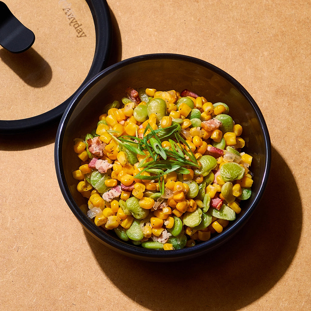 Flavorful succotash by Chef David Chang, cooked in the microwave using the glass Anyday dish, combining tender vegetables with a rich, savory broth. Enjoy a quick and vibrant side dish, ready in minutes.