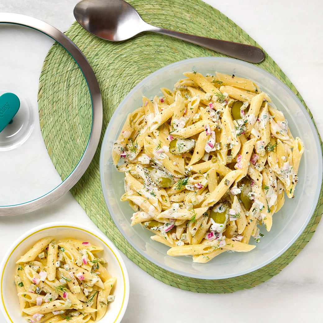 Dill Pickle Pasta Salad made and served in the glass Anyday dish, featuring pasta tossed with crunchy dill pickles, fresh herbs, and a tangy dressing.