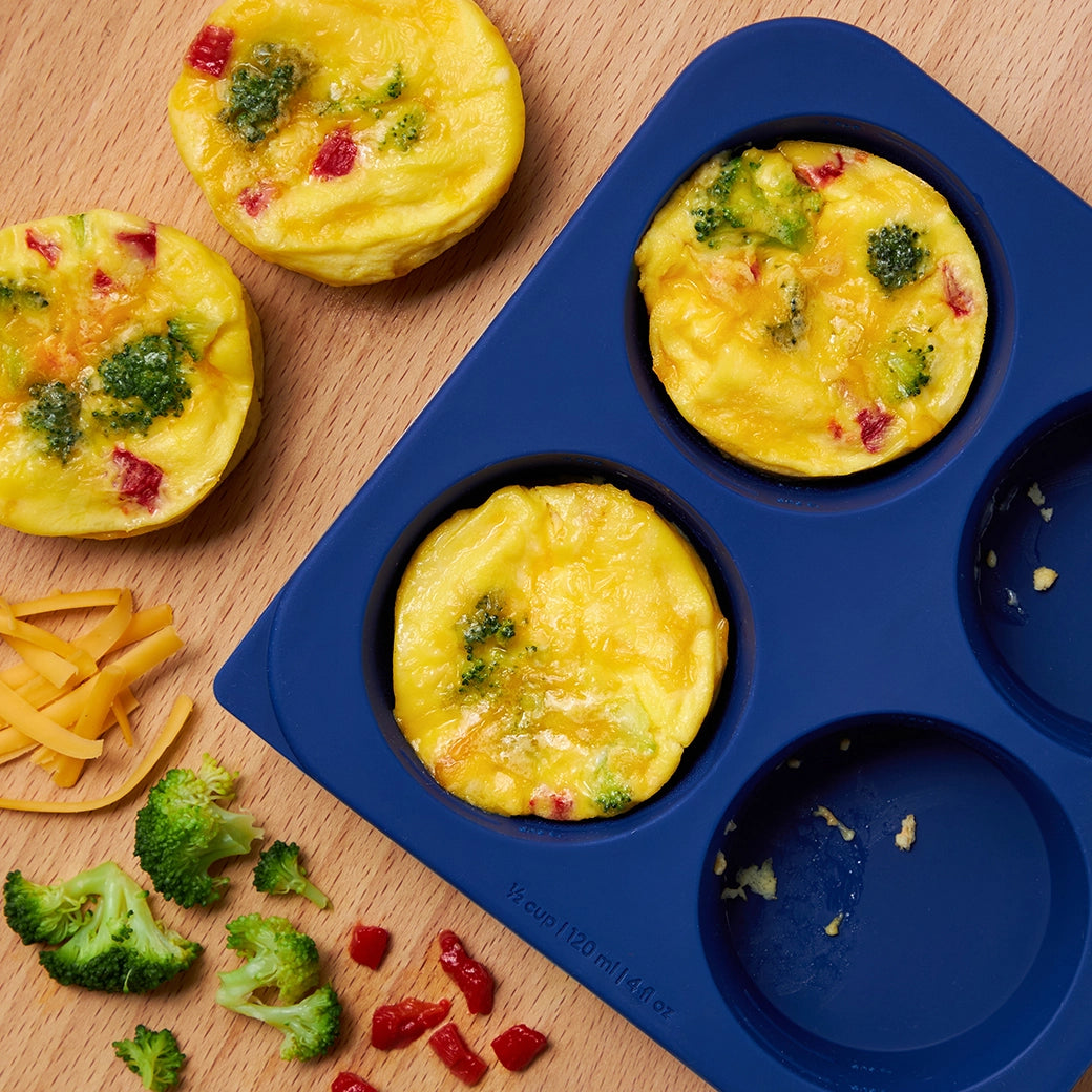 Quickly prepared egg bites made in the silicone Anytime Freezer Trays, consisting of fluffy eggs mixed with cheese, veggies, and meats. This method ensures perfectly cooked egg bites, ideal for a quick and nutritious breakfast.