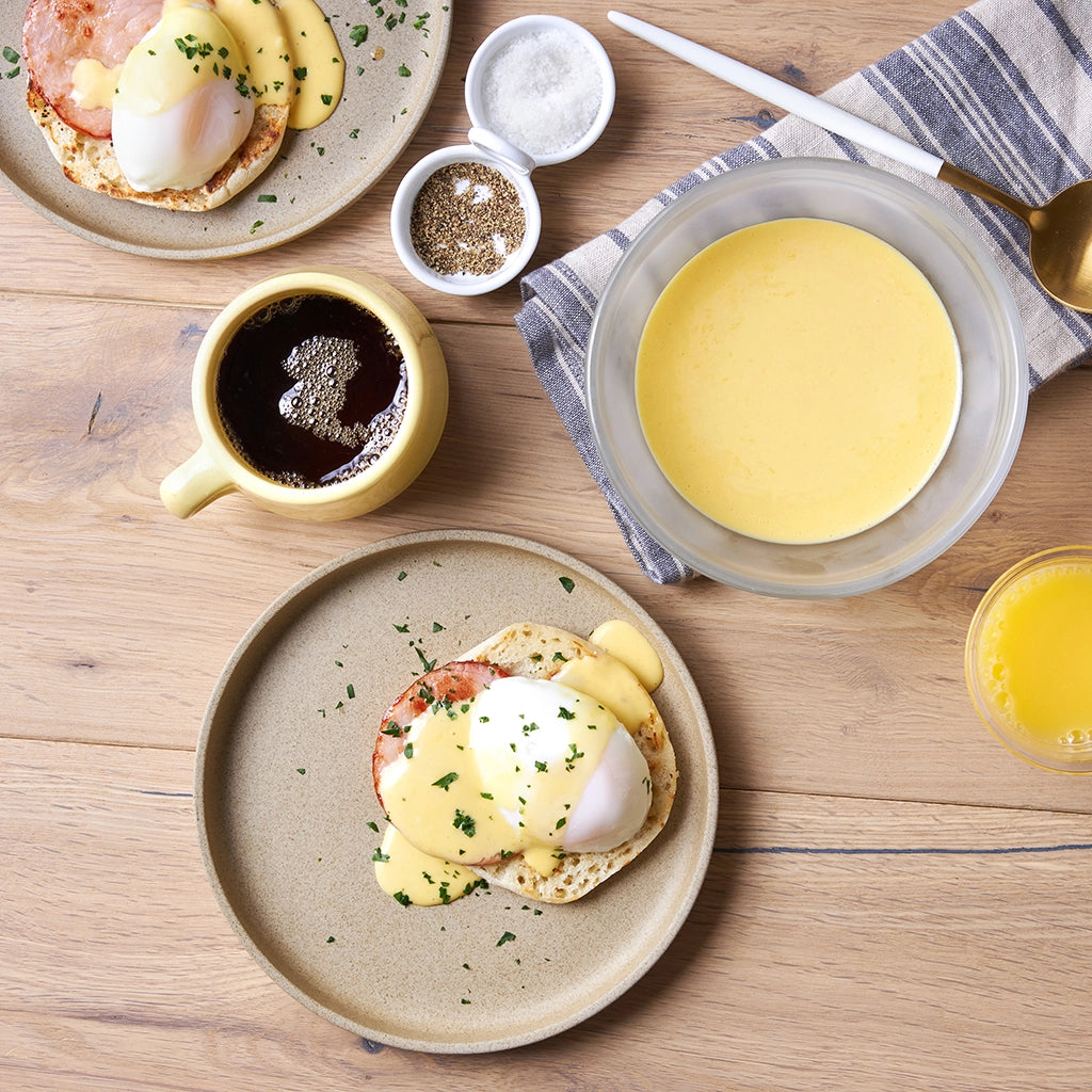 Microwave Eggs Benedict with Hollandaise Sauce made and served in the glass Anyday dish, featuring poached eggs on English muffins, topped with creamy hollandaise sauce.