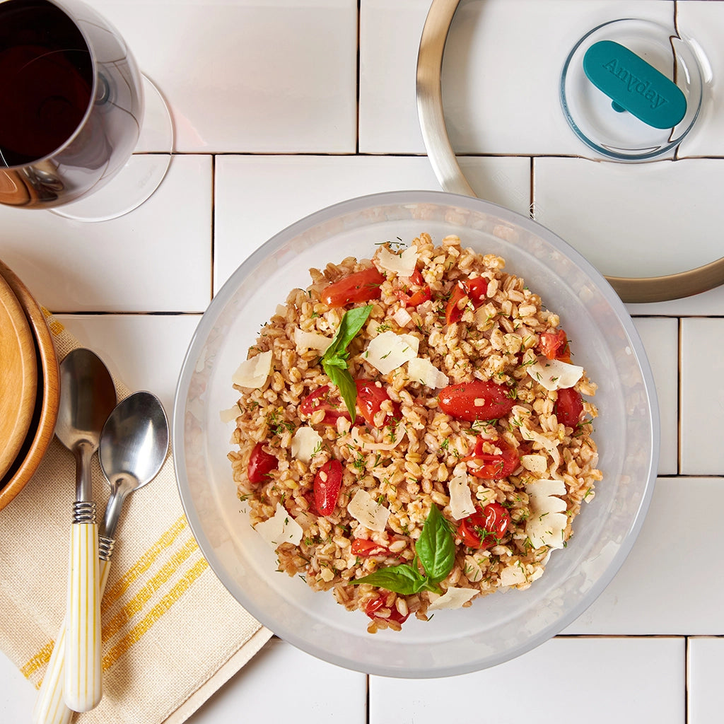 Warm farro with tomatoes, Parmesan, and basil cooked in the microwave using the glass Anyday dish, blending hearty farro with fresh, vibrant flavors. Enjoy a quick and wholesome meal, ready in minutes