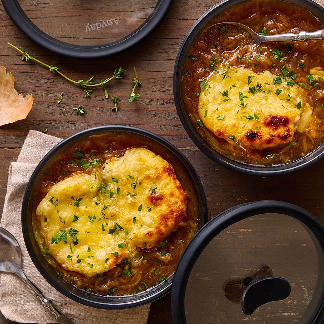 Microwave French Onion Soup made and served in the glass Anyday dish, featuring a rich broth with caramelized onions, topped with melted cheese and a slice of toasted bread.