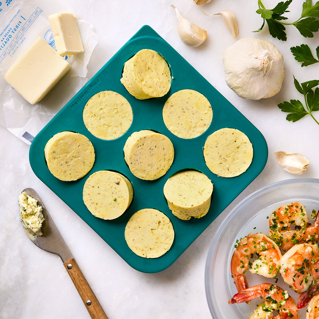 Garlic herb butter portions in an Anyday Anytime Freezer Tray, perfect for shrimp, seafood, chicken, rice, and vegetables. Made with fresh garlic, herbs, and butter for versatile flavor.