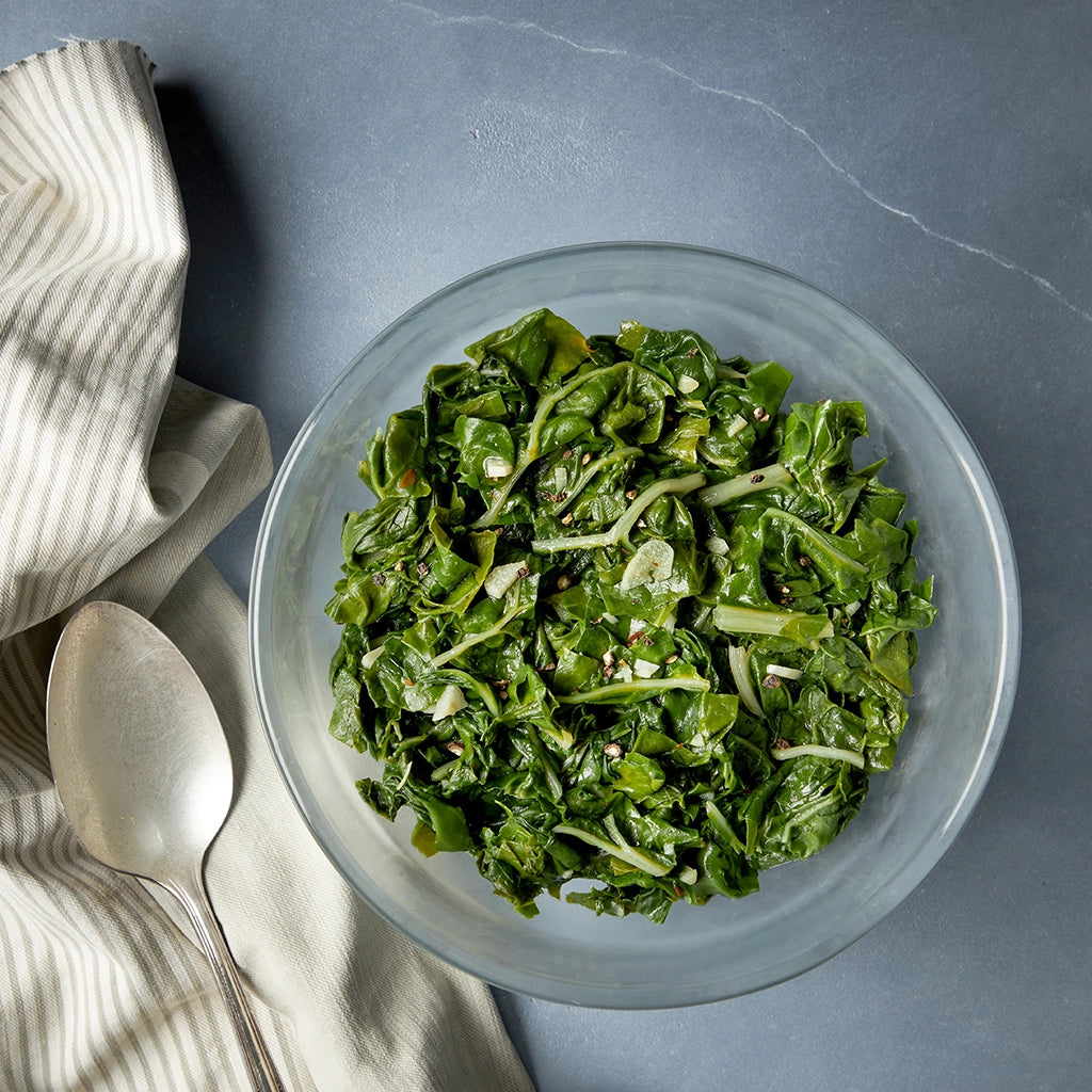 Garlicky Greens made and served in the glass Anyday dish, featuring tender greens sautéed with garlic for a flavorful and healthy side dish.