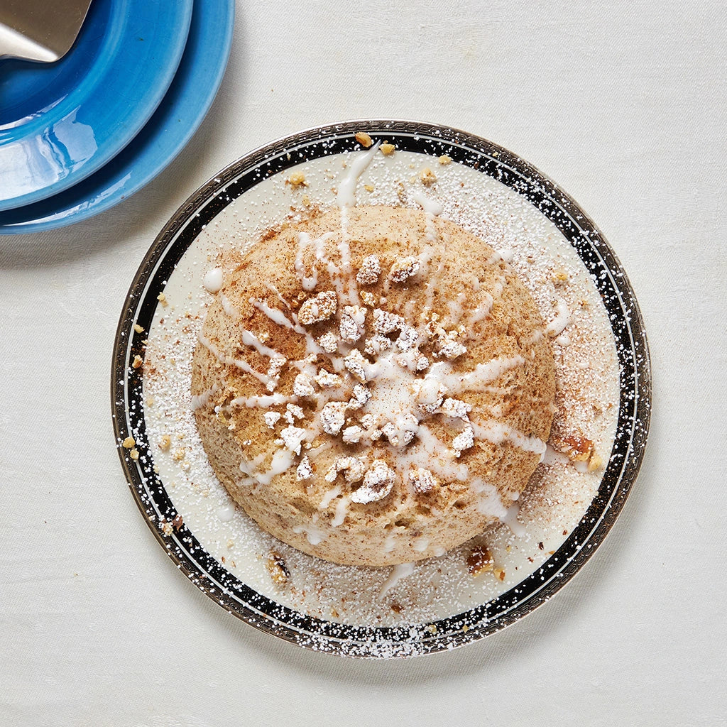 Honey Apple Cake with Walnuts made and served in the glass Anyday dish, with a moist cake featuring chunks of apple, drizzled with honey, and topped with crunchy walnuts.