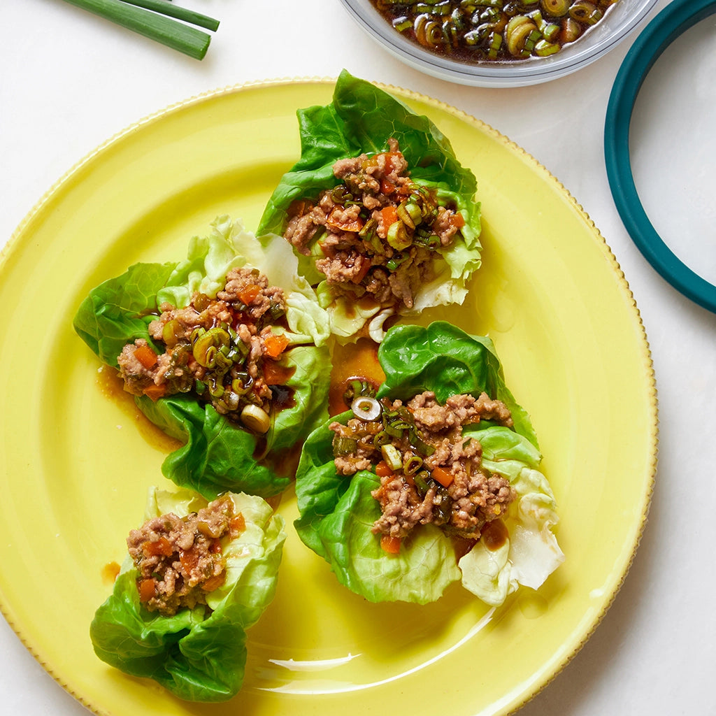 Deliciously cooked ground pork or chicken for easy lettuce wraps with scallion sauce, made and served in the glass Anyday dish. This method ensures tender meat and vibrant sauce, ideal for a quick and flavorful meal.