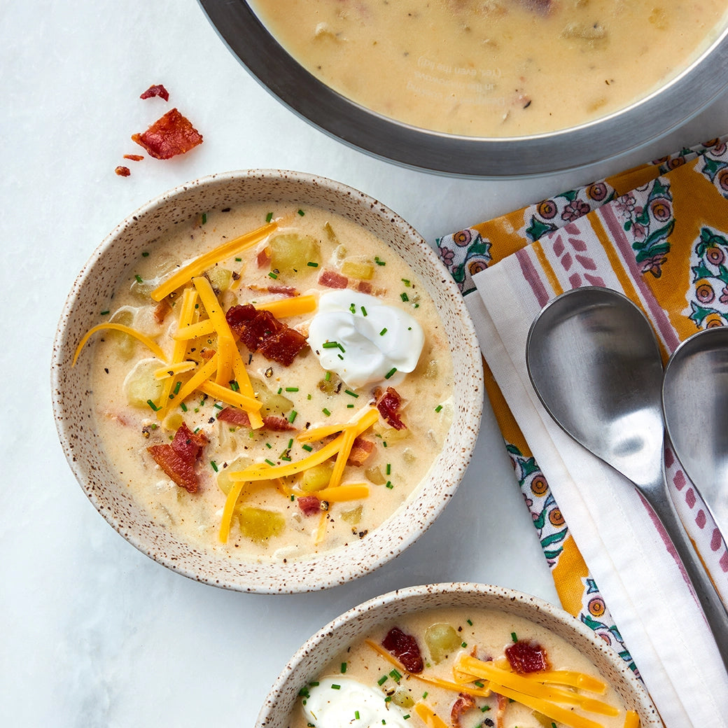 Deliciously cooked Loaded Baked Potato Soup made and served in the glass Anyday dish, with tender Yukon potatoes, bacon, onions, and heavy cream. This method ensures a rich and satisfying soup, perfect for a comforting meal.